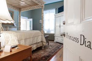 a bedroom with a bed and a dresser and a desk at Stone Maiden Inn in Stratford