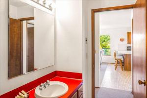 a bathroom with a red counter and a sink at Finch's Sunset Condo #16 in Moclips