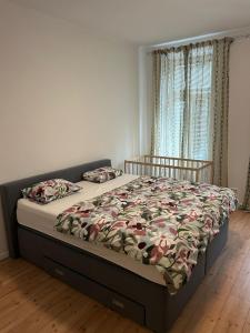 a bedroom with a bed with a comforter and a window at Favoriten Apartments in Vienna