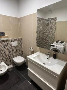a bathroom with a sink and a toilet at Favoriten Apartments in Vienna +10 photos