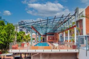 a building with a swimming pool in a city at Waterkant Loft in Cape Town