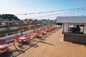 a row of chairs and tables on a balcony at htop Amatista - Bliss in Lloret de Mar +37 photos
