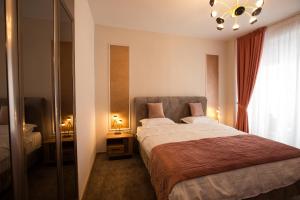 a bedroom with a large bed and a window at Al Centro in Bucharest +67 photos