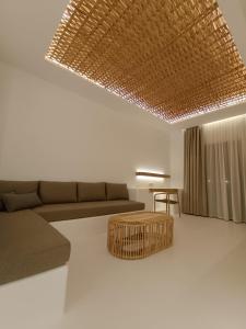 a living room with a couch and a table at Yialos Ios Hotel in Ios Chora