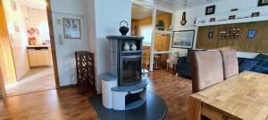 a living room with a fireplace on a table at Fischlandhus in Dierhagen +16 photos