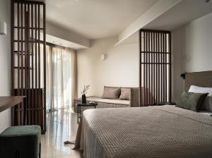 a bedroom with a bed and a couch at Admiral De Luxe in Zakynthos