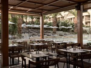 an outdoor dining area with tables and chairs at Admiral De Luxe in Zakynthos