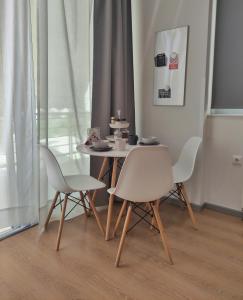 ein Tisch und Stühle in einem Raum mit einem Tisch in der Unterkunft Apartment A1 in Kalamata