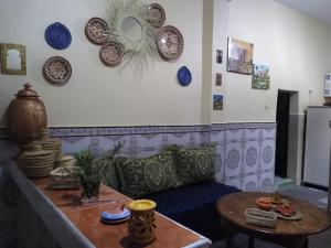 a living room with a couch and plates on the wall at Casa di Medina - Authentic Stay with Parking in Tiznit
