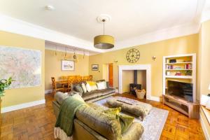 a living room with a couch and a fireplace at Tarn House in Elterwater