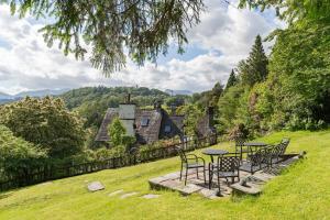 a group of chairs and a table in front of a house at Tarn House in Elterwater