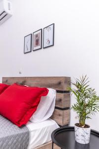 a bedroom with a red pillow and a table at Viola Apartment in Kissamos