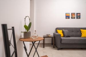 a living room with a couch and a table at Viola Apartment in Kissamos