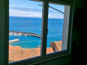 a window with a view of the ocean at Casa Laurentina Lastres in Lastres