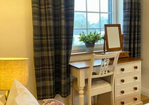 a desk with a mirror on a dresser next to a window at Bowland Breaks - Cobble View Cottage Cosy Retreat, Parking, Near Wedding Venues, Village Location with 3 great pubs in Waddington +11 photos