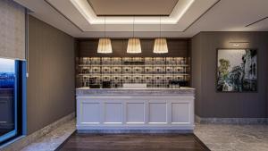 a bar in a hotel with two lights at By Otel Nilüfer in Bursa