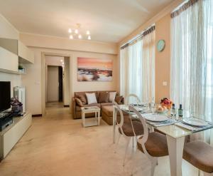 a living room with a table and a couch at Appartamenti Universal in Cattolica