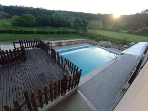 a large swimming pool with a fence around it at A Casa Da Canle in Braño