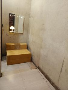 a room with a bench and a mirror on the wall at SIDHU GUEST HOUES -400 walking distance From golden Temple in Amritsar