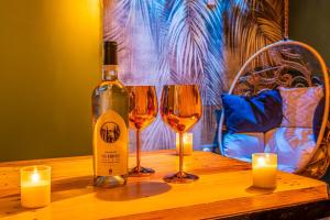 a bottle of wine and two glasses on a table at OIQIA • Bali in Narbonne +19 photos