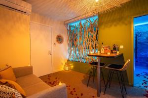 a living room with a couch and a table at OIQIA • Bali in Narbonne