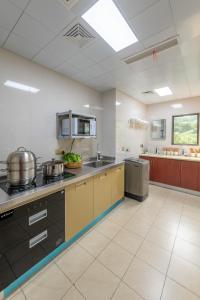 a large kitchen with pots and pans on the counters at Kaibu Courtyard Superior Apartment, Changjiang Cable Car Nanbin Road, Chongqing in Chongqing