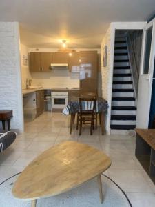 a kitchen and dining room with a table and a staircase at Maison Frères Prêcheurs in La Rochelle +15 photos