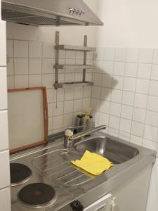 a kitchen sink with a yellow towel on it at Rosa Canina W2 in Kellenhusen