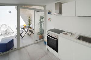 une cuisine avec un évier et une cuisinière four supérieur dans l'établissement Taormina Suite Downtown, à Taormine