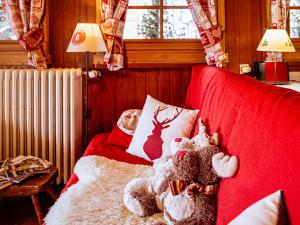 a teddy bear sitting on a bed in a bedroom at Appartement au centre Les Gets, 3 étoiles, 3 pers, proche télécabines et école de ski - FR-1-671-6 in Les Gets