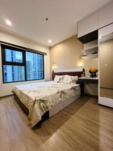 a bedroom with a large bed with a large window at Căn hộ 1PN 2 giường Vin Grand Park chỉ từ 550k in Gò Công
