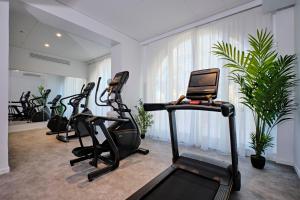 a gym with several treadmills and a laptop at Appart Hotel Odalys City Marseille Centre Euromed in Marseille +69 photos