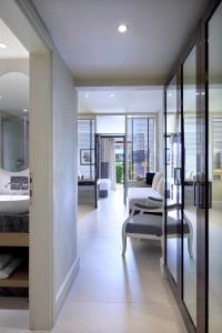 a hotel room with a bathroom and a bedroom at Princess Resort, Santikos Collection in Agia Paraskevi