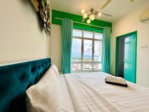 a bedroom with a large bed and a window at The Majestic Ipoh Town - Mountain View in Ipoh +54 photos