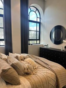a bedroom with a large bed and a mirror at Provincial Heritage CBD-Geelong in Geelong