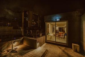 a view of a balcony of a building at night at Viajero Montevideo Hostel in Montevideo