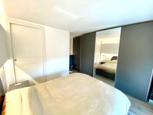 a bedroom with a white bed and a mirror at Lago 21 - Garden Terrace & Lake view in Pastrengo