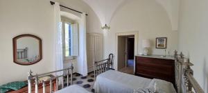 a bedroom with a bed and a mirror and a dresser at Villa Morea-Relax in piscina in Putignano