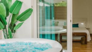 a view of a bathroom with a sink and a mirror at La Calita Escondida - Jacuzzi y Cocina en Terraza Privada - Piscina y Parking Gratis in Chiclana de la Frontera +32 photos