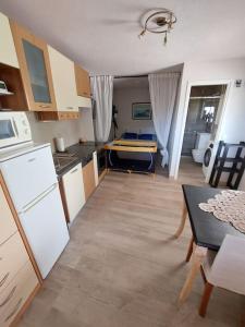 a kitchen with a room with a bed in it at Apartman-Cottage Grgec in Jelsa