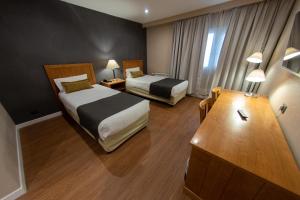 Cama ou camas em um quarto em Hotel Canal Beagle