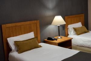 Cama ou camas em um quarto em Hotel Canal Beagle