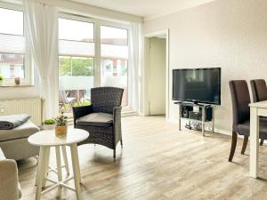 TV a/nebo společenská místnost v ubytování Sünnslag Wohnung 099
