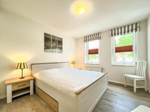 Postel nebo postele na pokoji v ubytování Sünnslag Wohnung 099