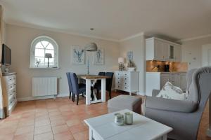 a living room with a couch and a table at Landhaus auf der Düne, App 2 in Rantum