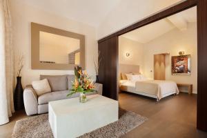 a living room with a couch and a bed at Villa Cosy, hotel & spa in Saint-Tropez