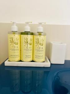 three bottles of soap are sitting on a shelf at B&B L'Agapanto in Capri