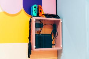 a toy cabinet with a mirror on a wall at Capsule Bonbon - Balneo - Sauna - Billard - Nintendo Switch in Douai