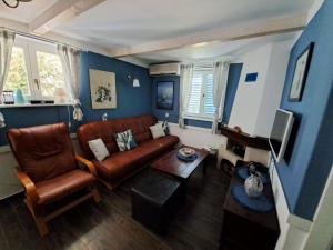 a living room with a couch and a table at Holiday Home Adricon in Grižane