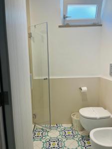 a bathroom with a toilet and a glass shower at B&B L'Agapanto in Capri